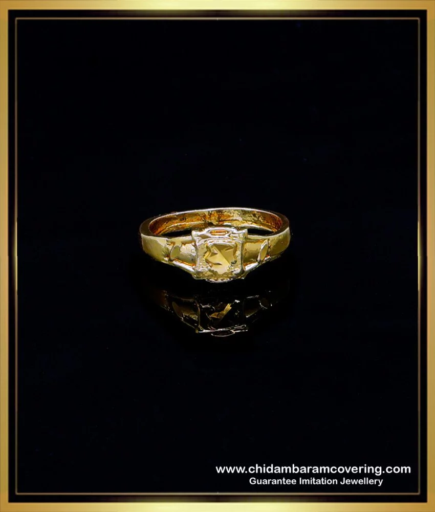 A small unique ((asymmetrical)) gold ring with dark green pear cut sapphire  and small diamonds, nature-inspired design, natural lighting,  ((photorealistic)), masterpiece, laying on pile of leaves on Craiyon